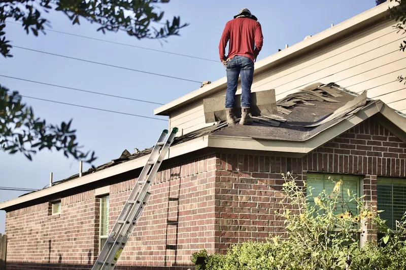 Professional roofer working on a residential roof in Willow Springs Ranch